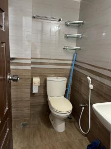 a bathroom with a toilet and a sink at Bashundhara Luxury 3BR Apartment Near Evercare in Dhaka