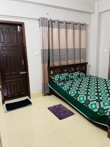 a bedroom with a bed next to a door at Bashundhara Luxury 3BR Apartment Near Evercare in Dhaka +9 photos