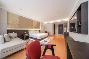 a hotel room with a bed and a couch at 北京刘家窑地铁站万信至格酒店 in Beijing