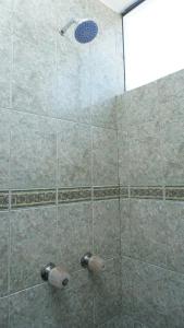 a shower with a glass door with a shower head at El Refugio de la Catedral in Yanahuara
