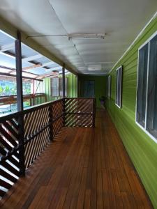 a room with green walls and a wooden deck at Eastern Star Trades 