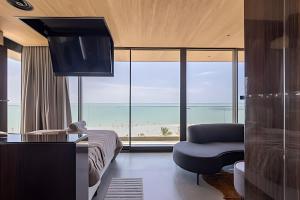 a hotel room with a view of the ocean at Edifício New Time, Seu Refugio a Beira Mar de Pajuçara in Maceió