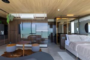 a bedroom with a bed and a dining room at Edifício New Time, Seu Refugio a Beira Mar de Pajuçara in Maceió +83 photos