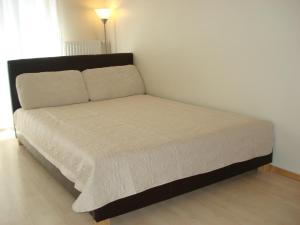 a bed in a small room with a white mattress at Riga Apartment Brivibas with Private Parking in Riga
