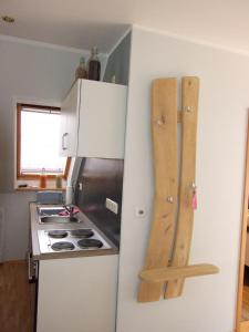 a kitchen with a stove and a white refrigerator at Ferienwohnung am Betschkamp in Schneverdingen