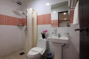 a white bathroom with a sink and a toilet at Horizon Hotel in Olongapo +250 photos