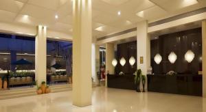 珠海市にあるCatic Hotel--Adjacent Bulidingの柱と照明のあるホテルのロビー