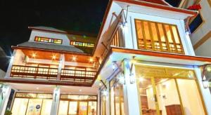 two story building with lights in the night at The Indigo House Phrae in Phrae