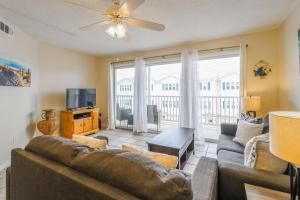 a living room with a couch and a tv at Tybee Summer Winds 523 Condo in Tybee Island
