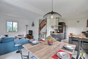 a kitchen and a living room with a dining table at Ker wan in Plérin