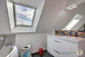 a bathroom with a sink and a window at Ker wan in Plérin +24 photos