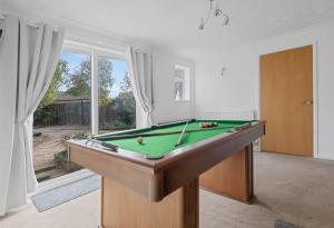 a living room with a pool table and a window at Awesome Games Room House! EMA Donington Park, with FREE parking in Kegworth