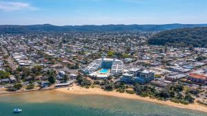 an aerial view of a beach and buildings at Allure in Ettalong Beach