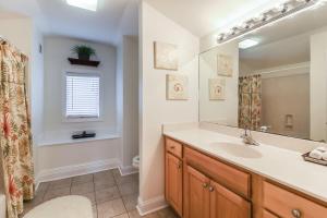 a bathroom with a sink and a large mirror at Sea Sight Villa B in Tybee Island +19 photos
