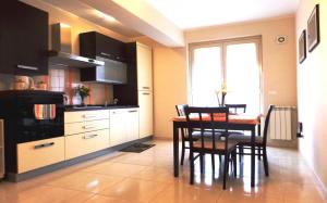 a kitchen and dining room with a table and chairs at Nerissa Holiday Apartment Milazzo in Milazzo