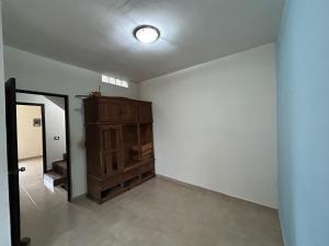 an empty room with a wooden cabinet and a door at Eclipse in Villahermosa