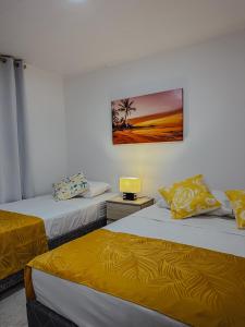 a room with two beds and a picture on the wall at Ketlina Village Grandpas House in Jacob