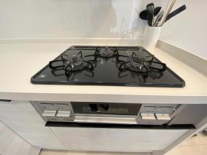 a stove top oven sitting on a kitchen counter at THE FEEL ONNA 2 / Vacation STAY 18771 in Onna
