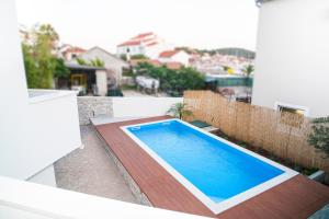 a swimming pool on the balcony of a house at Apartment Ema in Rogoznica