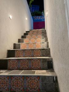 a set of stairs with colorful tiles on them at Casa Santorini in Cartagena de Indias