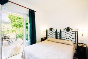 a bedroom with a bed and a large window at Villino Eleonora in Parghelia