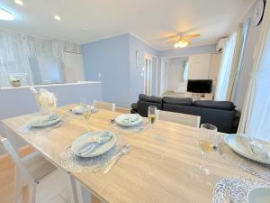 a dining room and living room with a table and chairs at THE FEEL ONNA 2 / Vacation STAY 18769 in Onna