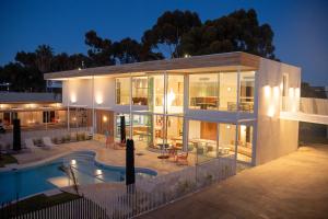 a large house with a swimming pool at night at Kar-Rama Hotel in Mildura