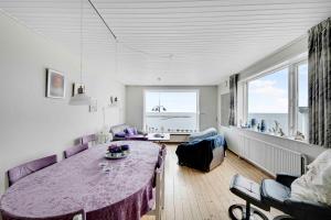 a living room with a purple table and a couch at Spacious House With Sea Views From All Rooms in Rønne