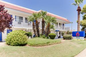 a hotel with palm trees in front of a building at Motel 6-Tempe, AZ - Scottsdale South in Tempe