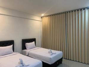 Postel nebo postele na pokoji v ubytování jungle senaru cottage