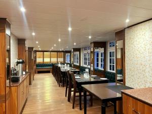 a large dining room with tables and chairs at Mount Thistle Boutique Hotel in Darjeeling
