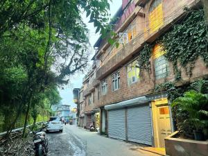 a car parked on a street next to a building at Mount Thistle Boutique Hotel in Darjeeling