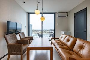 a living room with a couch and a table at Cottage TAIZA in Kyotango