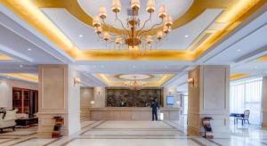 a large lobby with a chandelier on the ceiling at Vienna Hotel Anhui Fuyang Funan Bailing Apartment in Funan