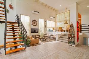a large living room with a staircase and a living room at Casa BaruGrande in Cartagena de Indias