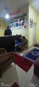 a person laying on a couch in a living room at SAI Guest House at Gangtok Taxi Stand in Gangtok