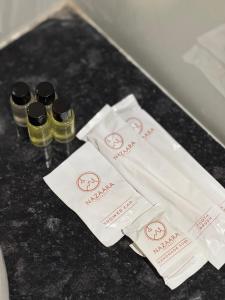 a table with two bottles of oil and two bags at Nazaara Hills Retreat in Thūr