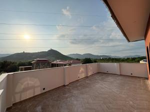 a balcony with a view of the mountains at Nazaara Hills Retreat in Thūr +15 photos
