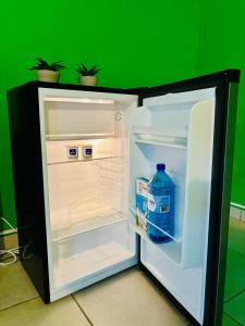 an open refrigerator with a bottle of water in it at Cozy 2 Bedroom near Kruger in Hectorspruit