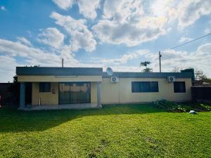 a house with a grass yard in front of it at Cozy 2 Bedroom near Kruger in Hectorspruit