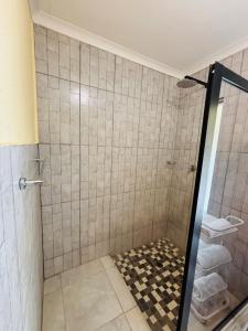 a bathroom with a shower with a checkeredkeredkered at Cozy 2 Bedroom near Kruger in Hectorspruit +13 photos