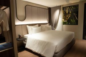 a bedroom with a white bed and a window at Richmann Resort Hotel Hatyai in Hat Yai +230 photos