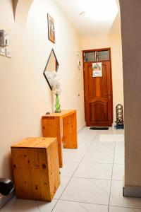 a hallway with a table and a mirror and a door at Ubuntu Stays in Mombasa