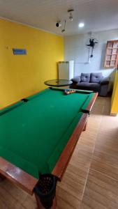 a living room with a pool table and a couch at Casa de praia em Maria Farinhaa - Paulista in Paulista