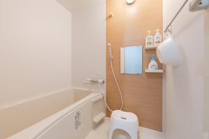 a bathroom with a white toilet and a bath tub at Planetarium N in Yamashitachō +21 photos