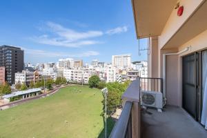 a balcony with a view of a park in a city at Planetarium N in Yamashitachō