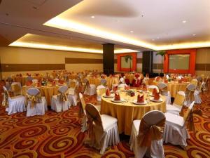 a large banquet hall with tables and chairs at Grand Surya Hotel Kediri in Kediri +185 photos
