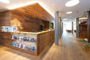 a bar in a restaurant with a wooden wall at Titlis Resort in Engelberg