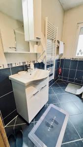 a bathroom with a sink and a mirror on the floor at Guest House Bosnian House in Sarajevo +46 photos
