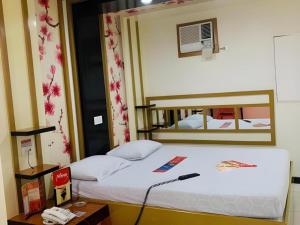 a bedroom with a bed with a mirror on the wall at Hotel Sogo Tarlac in Suizo +69 photos